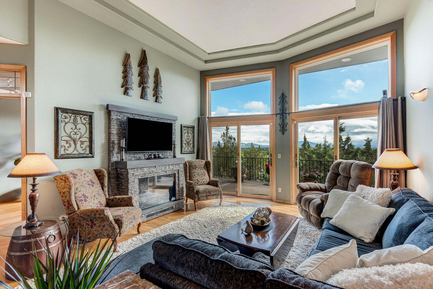 2434 Southwest 34th Drive Redmond, OR 97756 - Photo 5 of 36 a living room with furniture a flat screen tv and a floor to ceiling window