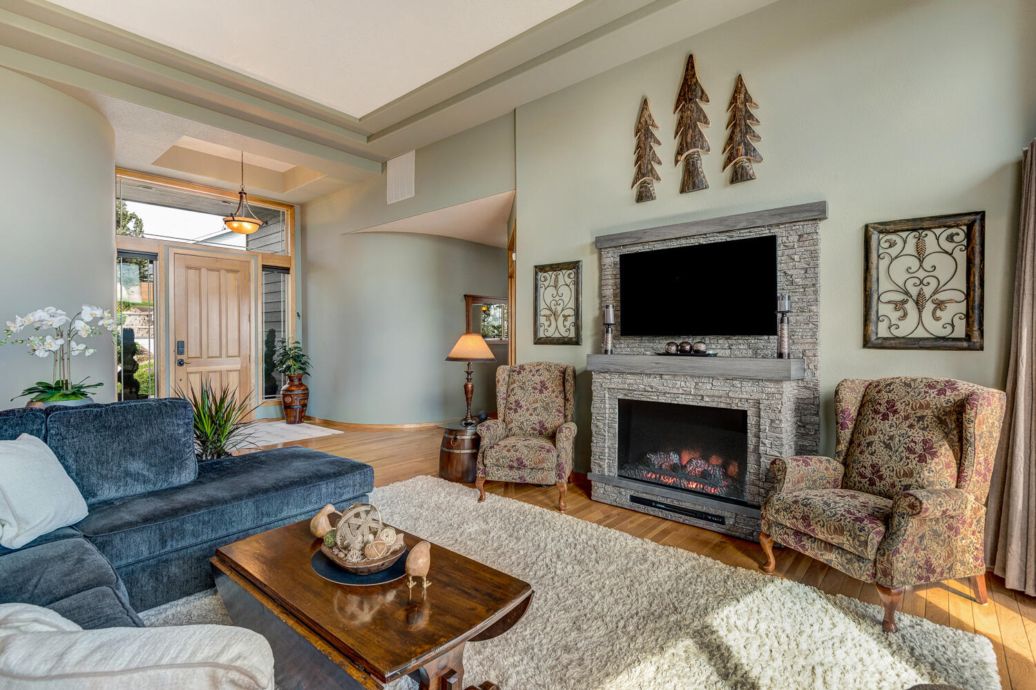2434 Southwest 34th Drive Redmond, OR 97756 - Photo 7 of 36 a living room with furniture a flat screen tv and a fireplace