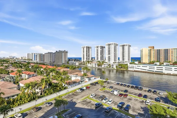 a view of a tall building with a swimming pool and sitting area