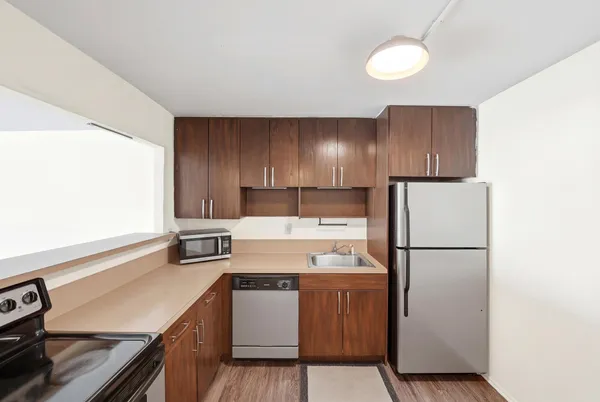 a kitchen with a refrigerator sink and stove