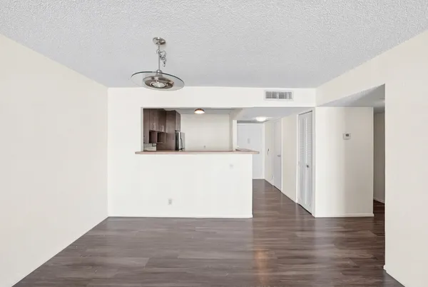 a view of a room with wooden floor and windows