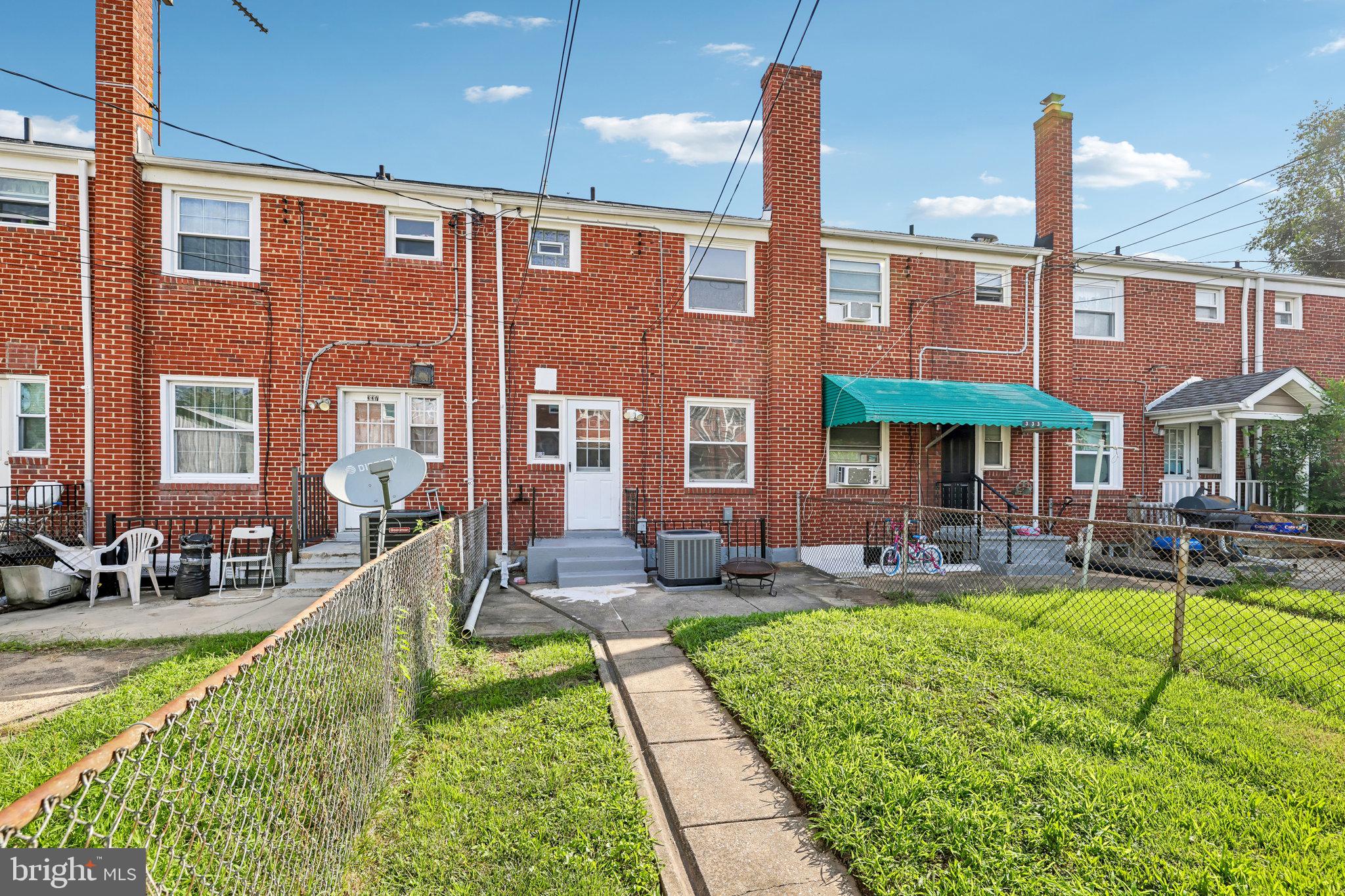 335 Torner Road Baltimore, MD 21221 - Photo 21 of 25 Charming brick townhome with green lawn.