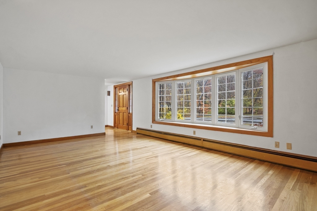 116 Waverly Street Ashland, MA 01721 - Photo 14 of 35 a view of an empty room with wooden floor and a window