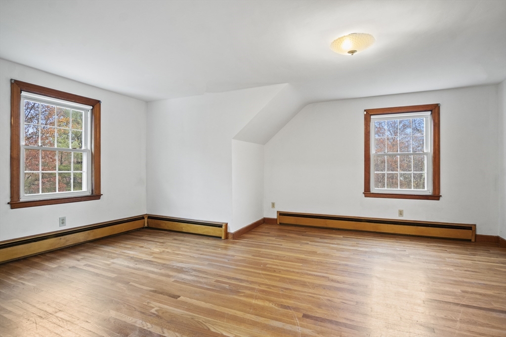 116 Waverly Street Ashland, MA 01721 - Photo 19 of 35 a view of an empty room with wooden floor and a window
