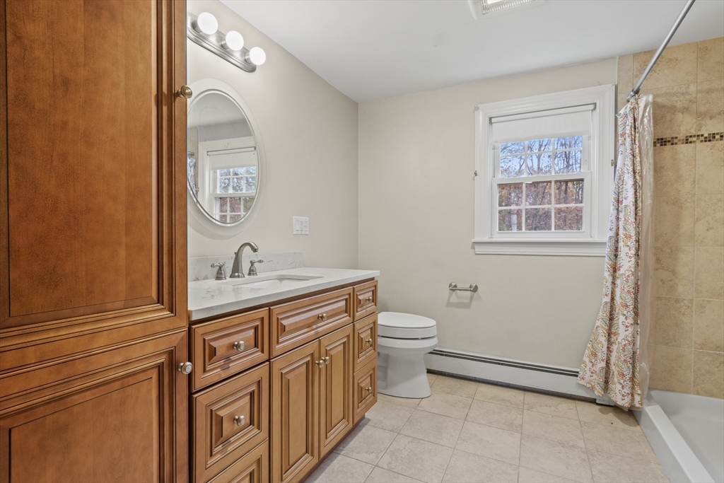 116 Waverly Street Ashland, MA 01721 - Photo 6 of 35 a bathroom with a granite countertop toilet and sink