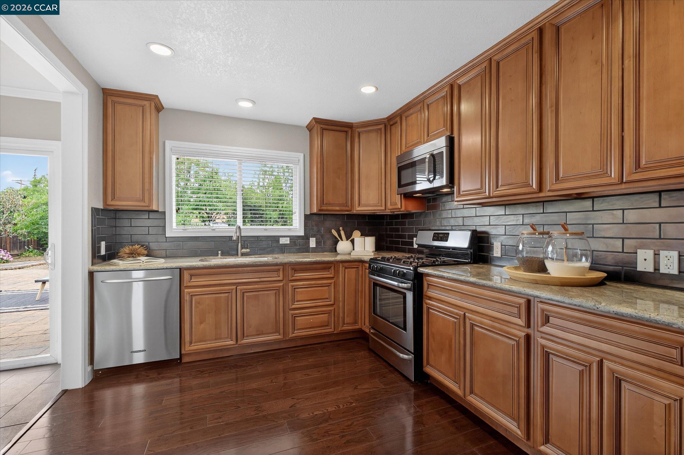 4092 Nulty Drive Concord, CA 94521 - Photo 11 of 33 a kitchen with stainless steel appliances granite countertop a stove a sink dishwasher and a refrigerator