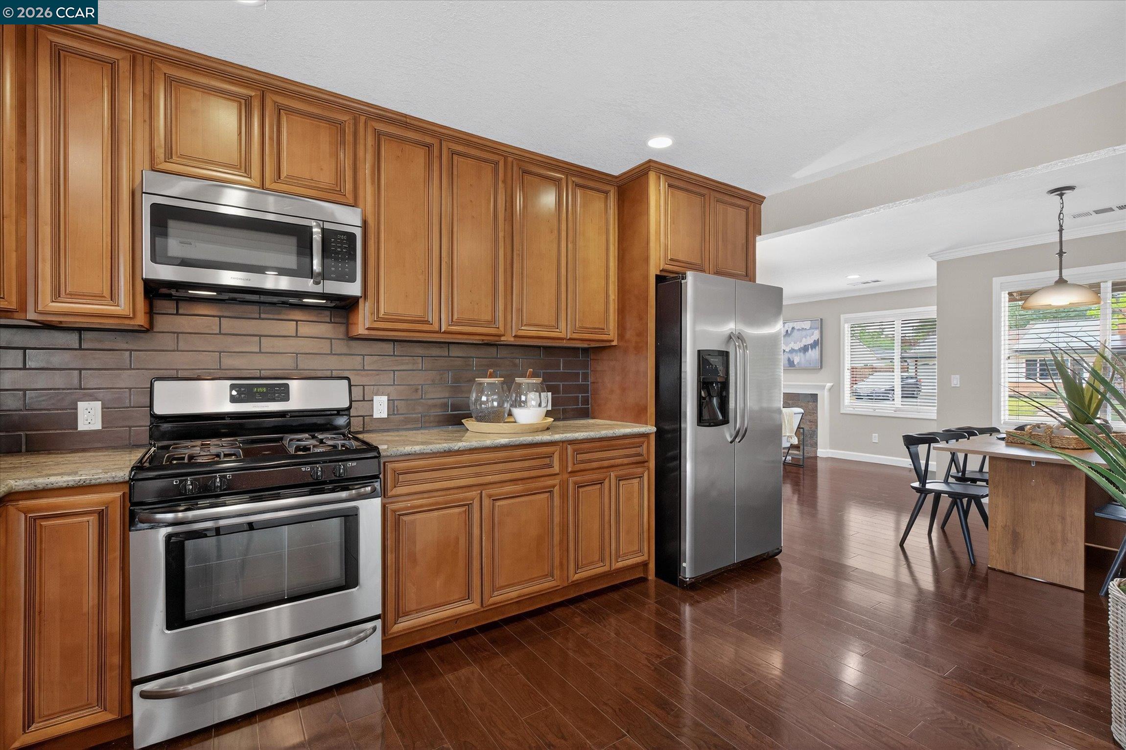 4092 Nulty Drive Concord, CA 94521 - Photo 10 of 33 a kitchen with granite countertop a refrigerator stove and wooden floor