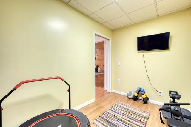 a bathroom with a granite countertop sink vanity mirror and toilet