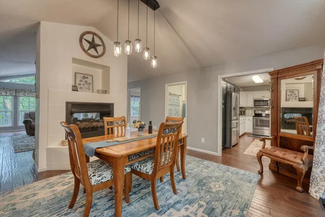 a dining room with furniture and wooden floor