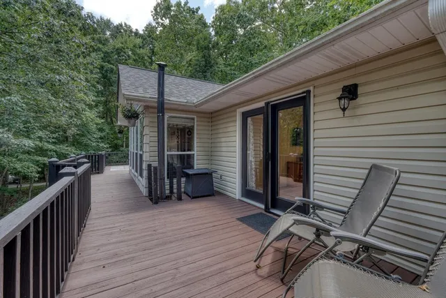 a view of a porch with wooden floor and furniture