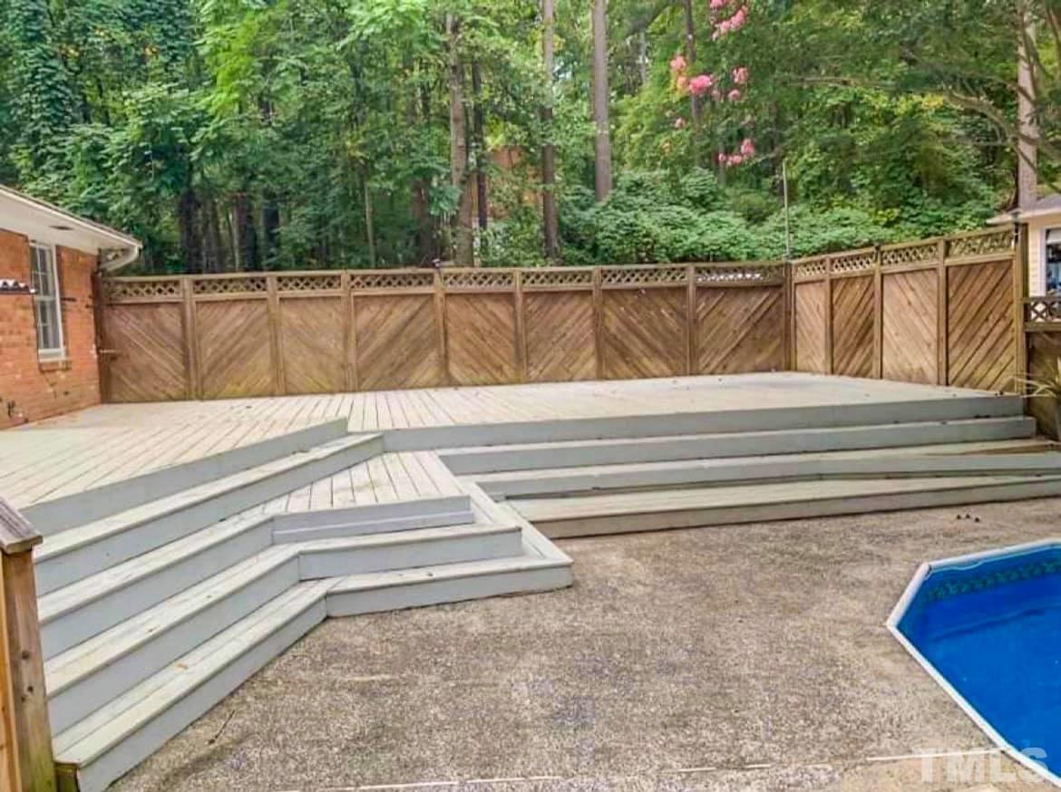 5601 Russell Road Durham, NC 27712 - Photo 10 of 10 a view of backyard with wooden fence and large trees