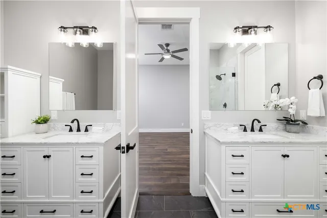 a bathroom with a double vanity sink mirror and