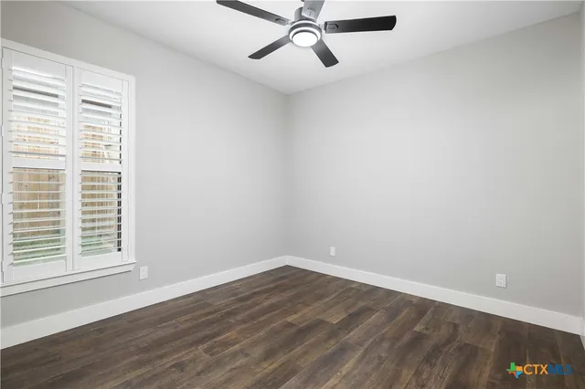 a view of a room with wooden floor and windows