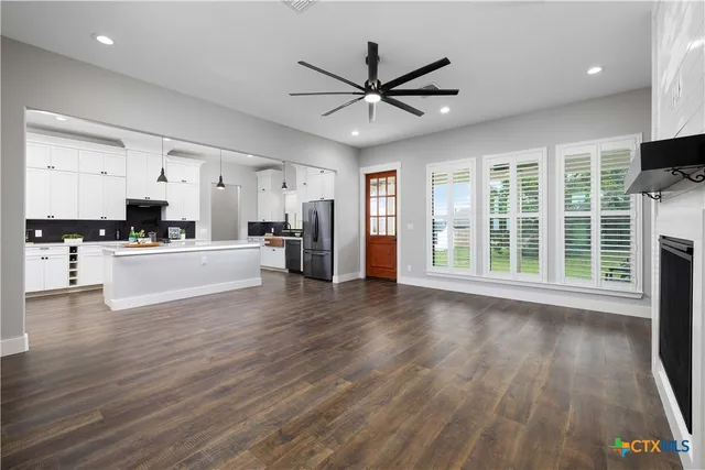 a view of a kitchen with wooden floor and a window