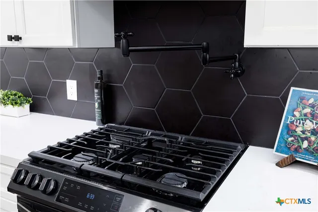 a stove top oven sitting inside of a kitchen