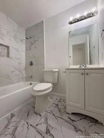 a bathroom with a toilet a sink and bathtub