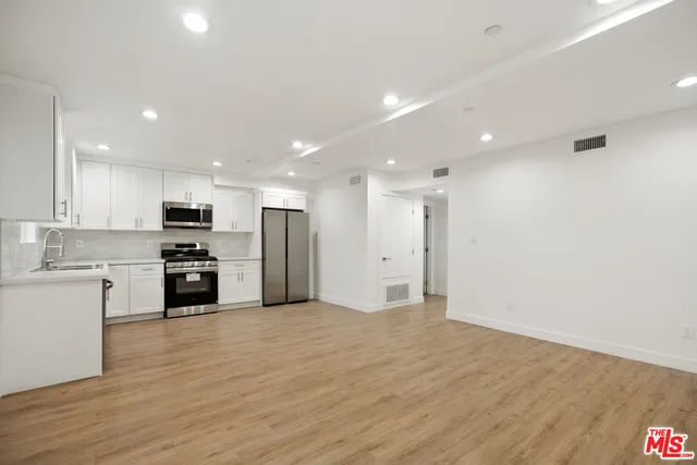a view of kitchen with stainless steel appliances refrigerator oven microwave and stove
