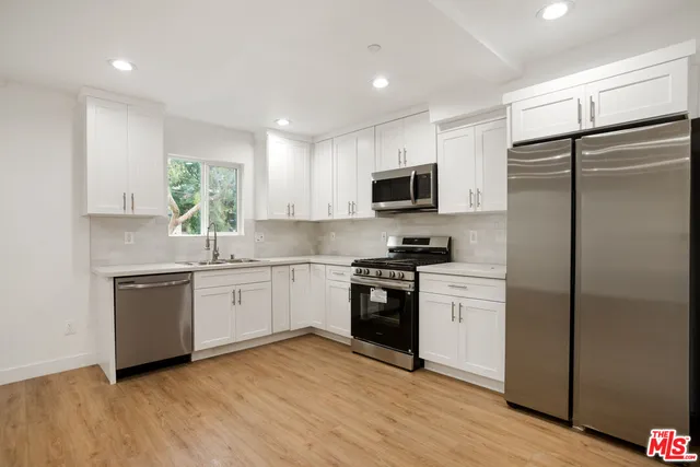 a kitchen with a refrigerator stove and microwave