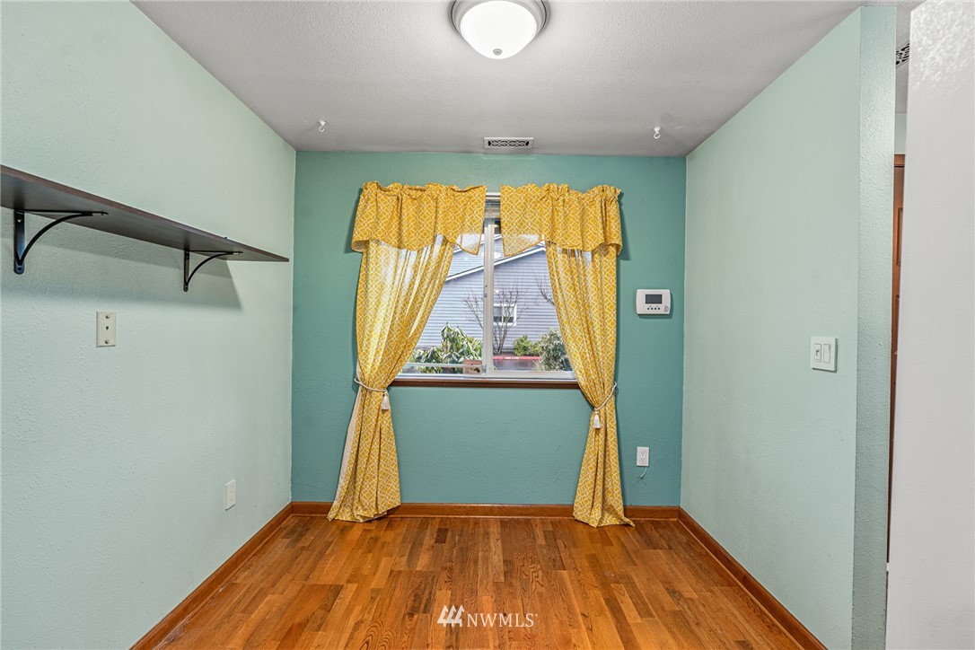 21527 4th Avenue West, Unit C43 Bothell, WA 98021 - Photo 3 of 27 a view of a room with wooden floor a ceiling fan and window