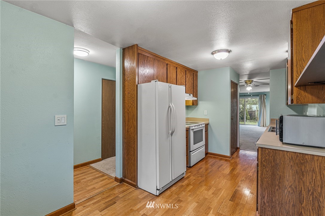 21527 4th Avenue West, Unit C43 Bothell, WA 98021 - Photo 8 of 27 a kitchen with stainless steel appliances granite countertop a refrigerator and a stove top oven