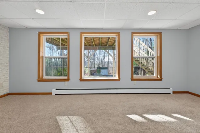 a view of a room with wooden floor and windows