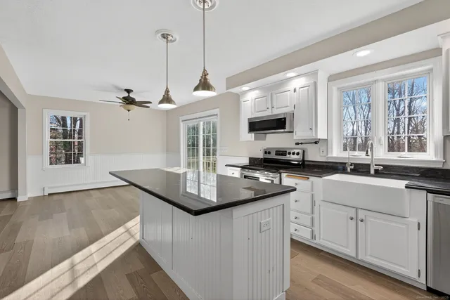 a view of kitchen with sink microwave and refrigerator