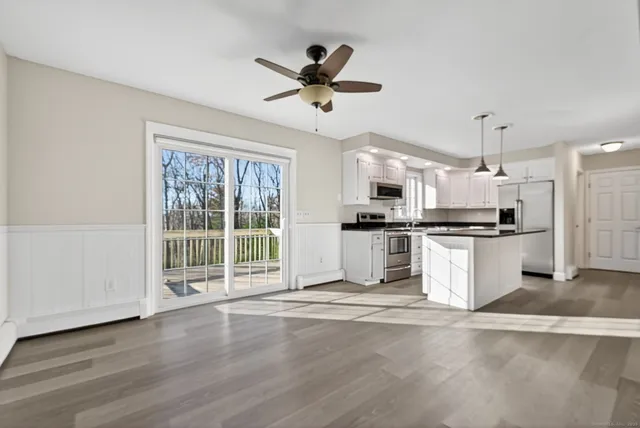 a view of kitchen with sink oven and window