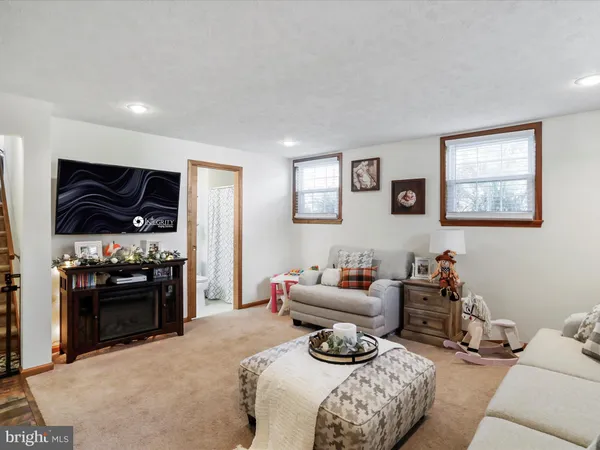 a bedroom with furniture and a flat screen tv
