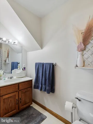 a bathroom with a sink a toilet and mirror