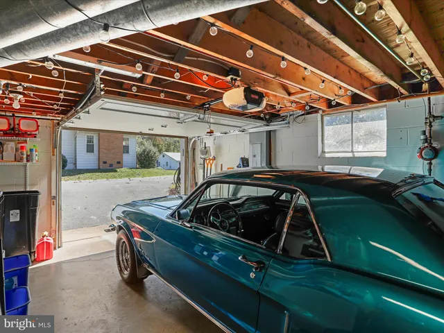 a view of a car and car parked in garage