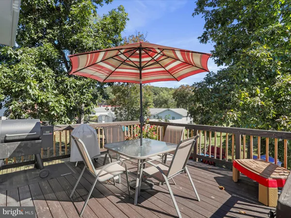 a view of a chair and table on the deck