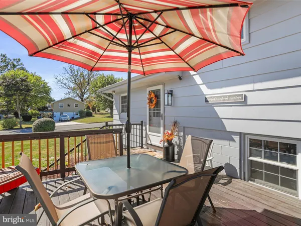 a balcony with table and chairs