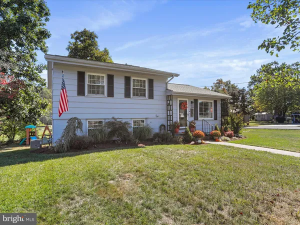 a view of house with yard and outdoor seating