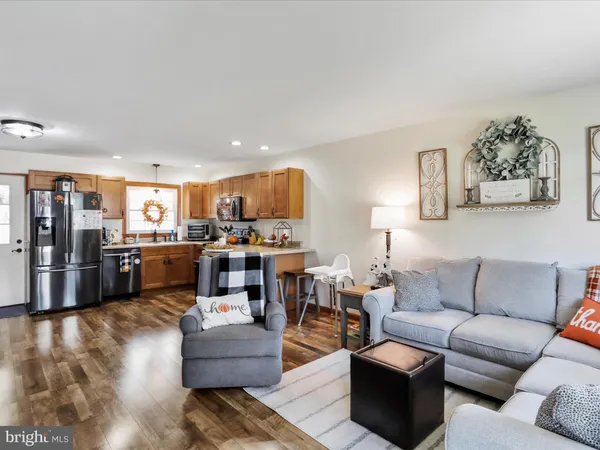 a living room with furniture and kitchen view