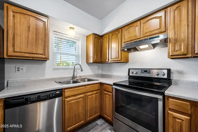 a kitchen with stainless steel appliances granite countertop a stove and cabinets