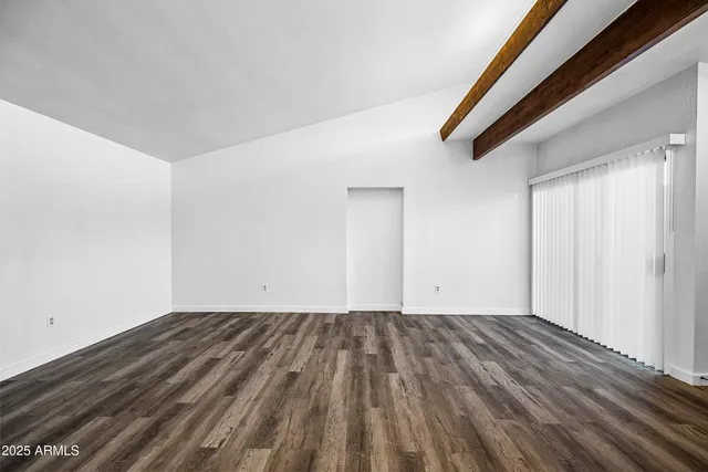 a view of room with wooden floor and window