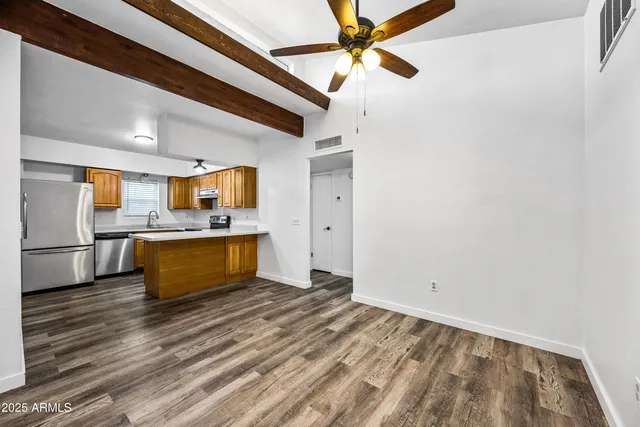 a kitchen with stainless steel appliances granite countertop a sink a stove and a refrigerator