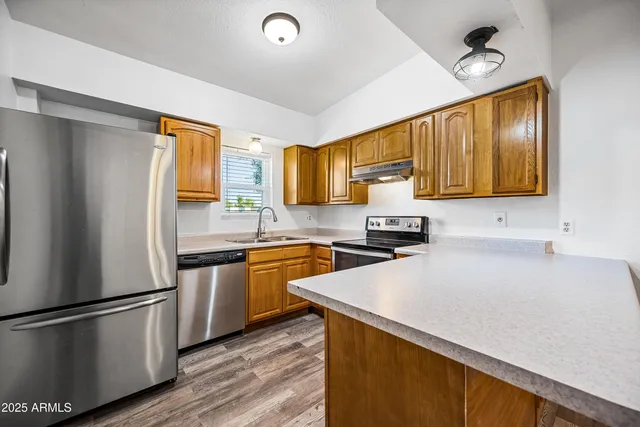 a kitchen with stainless steel appliances a stove sink and cabinets