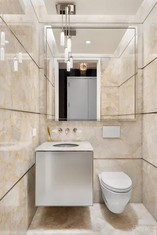 a bathroom with a sink a toilet and mirror