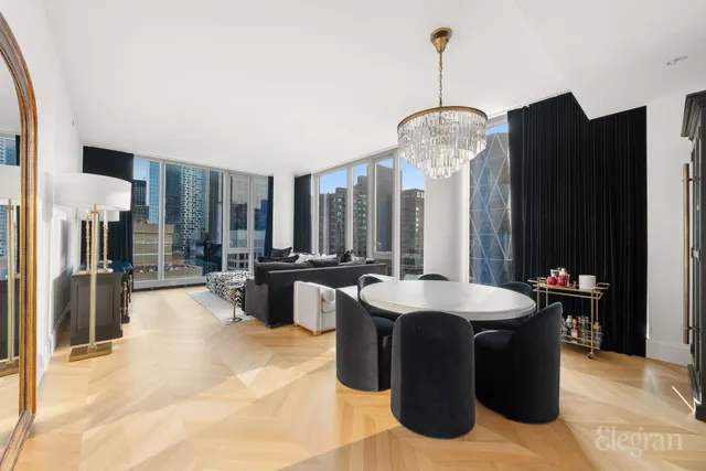 a large living room with furniture and large windows