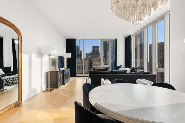 a dining hall with couches a table and chairs