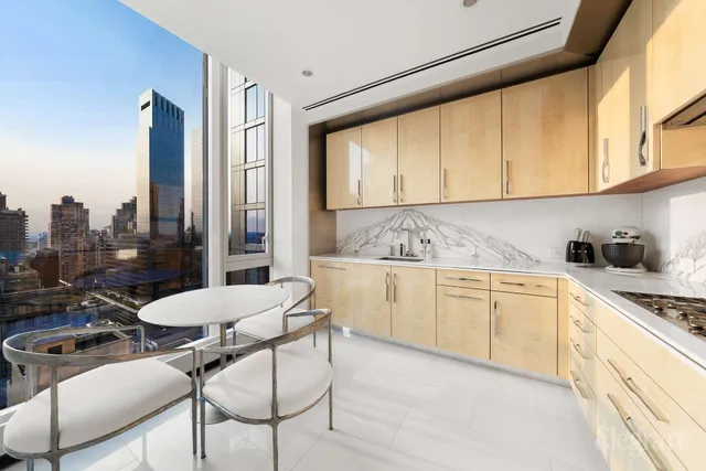 a kitchen with a stove a refrigerator and cabinets
