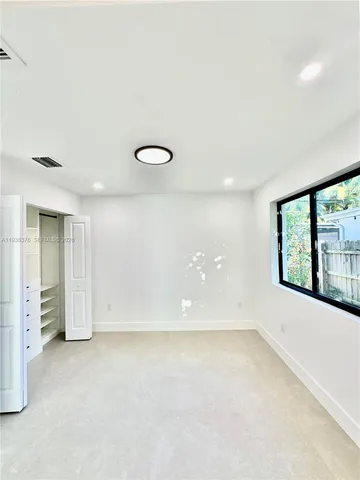 a view of kitchen with cabinets and a refrigerator