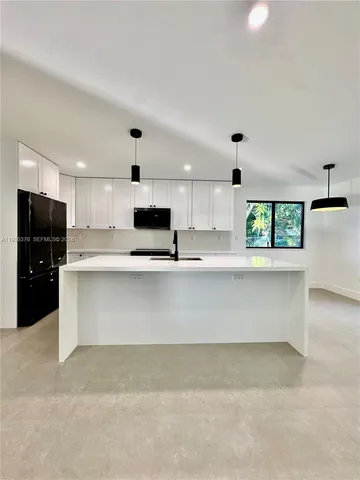 a spacious bathroom with double sink a toilet a shower and a mirror