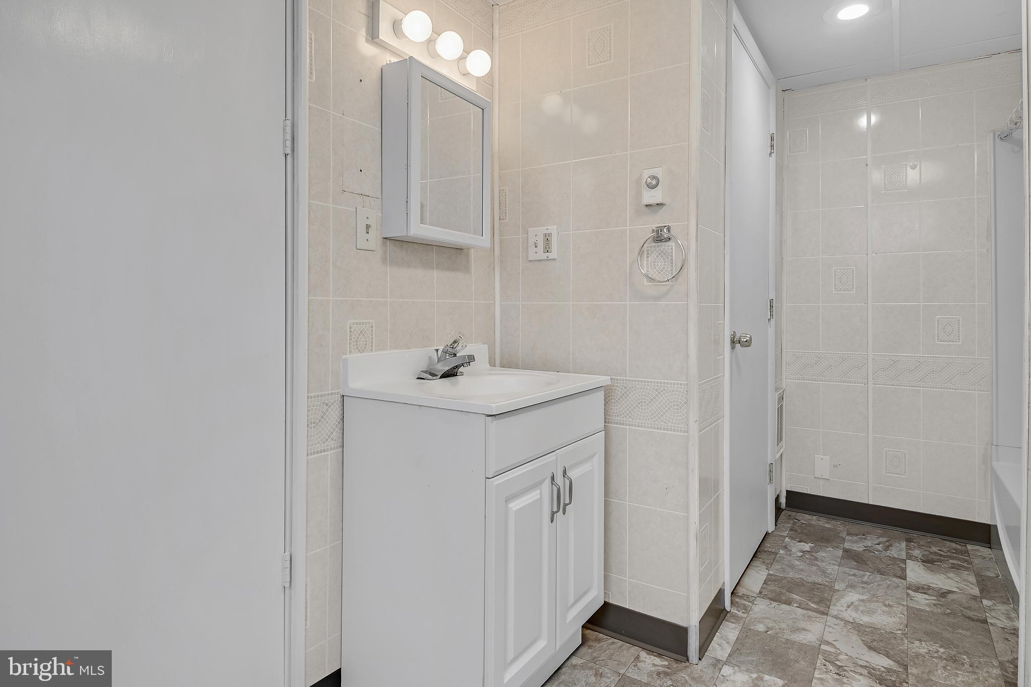 440 Market Street New Cumberland, PA 17070 - Photo 10 of 10 a bathroom with a sink a mirror and shower