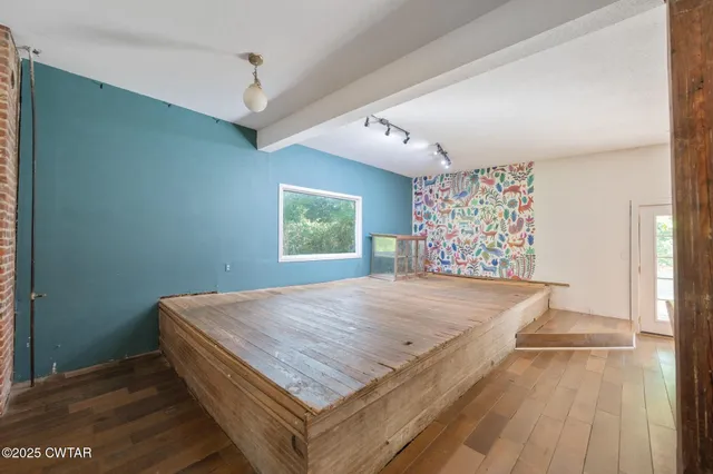 a kitchen with a sink a counter top space and stainless steel appliances