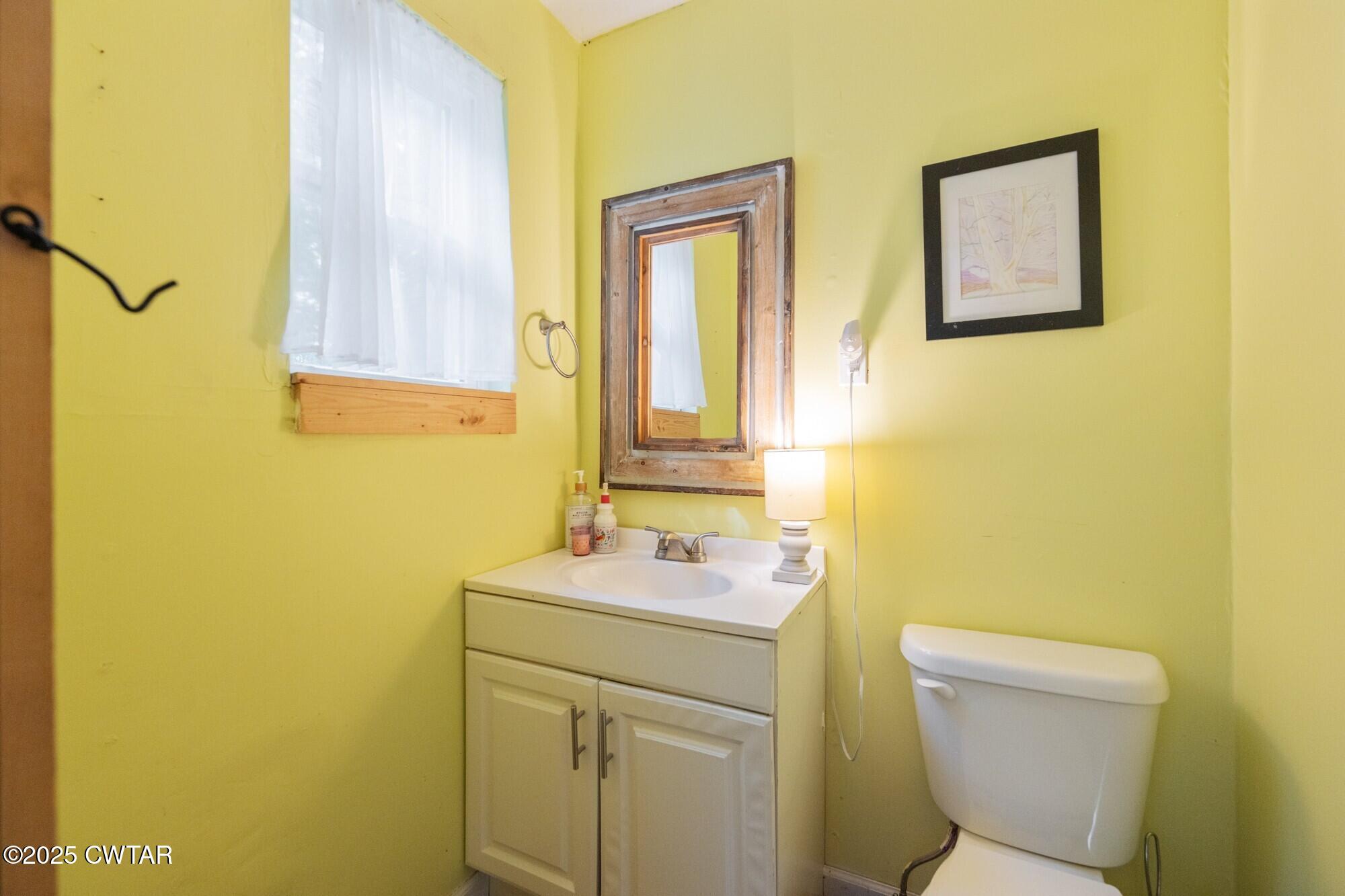 1035 Beacon Road Parsons, TN 38363 - Photo 22 of 70 a bathroom with a sink mirror vanity and toilet