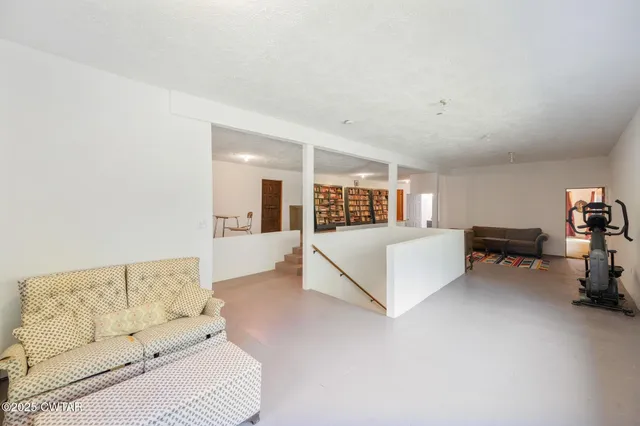 a view of a livingroom with furniture and a window