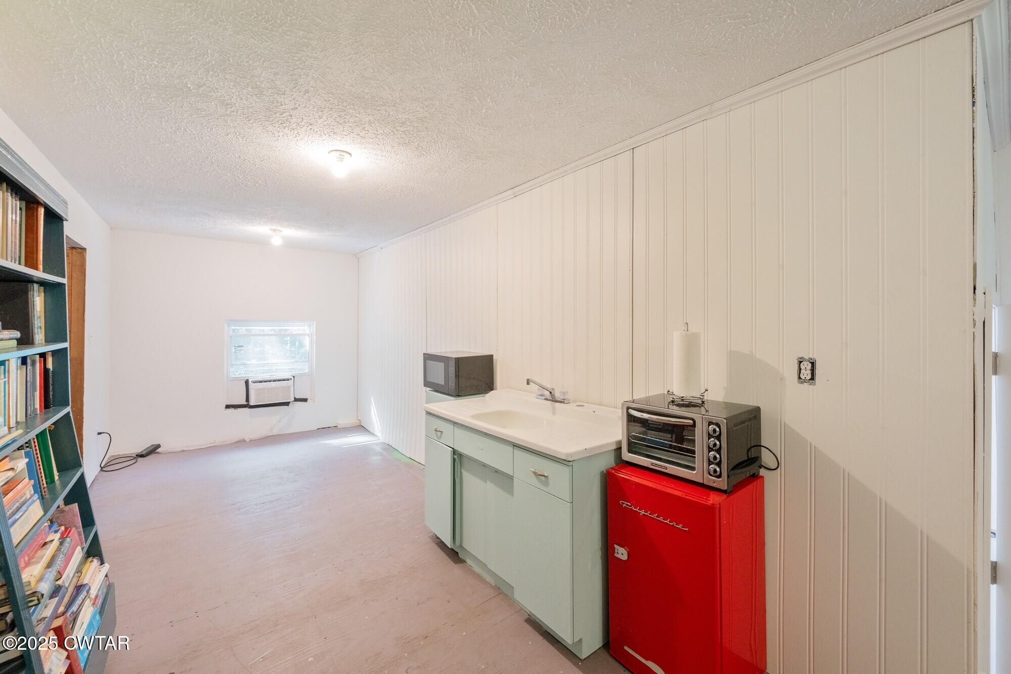 1035 Beacon Road Parsons, TN 38363 - Photo 39 of 70 a kitchen with stainless steel appliances granite countertop a stove a sink and a refrigerator