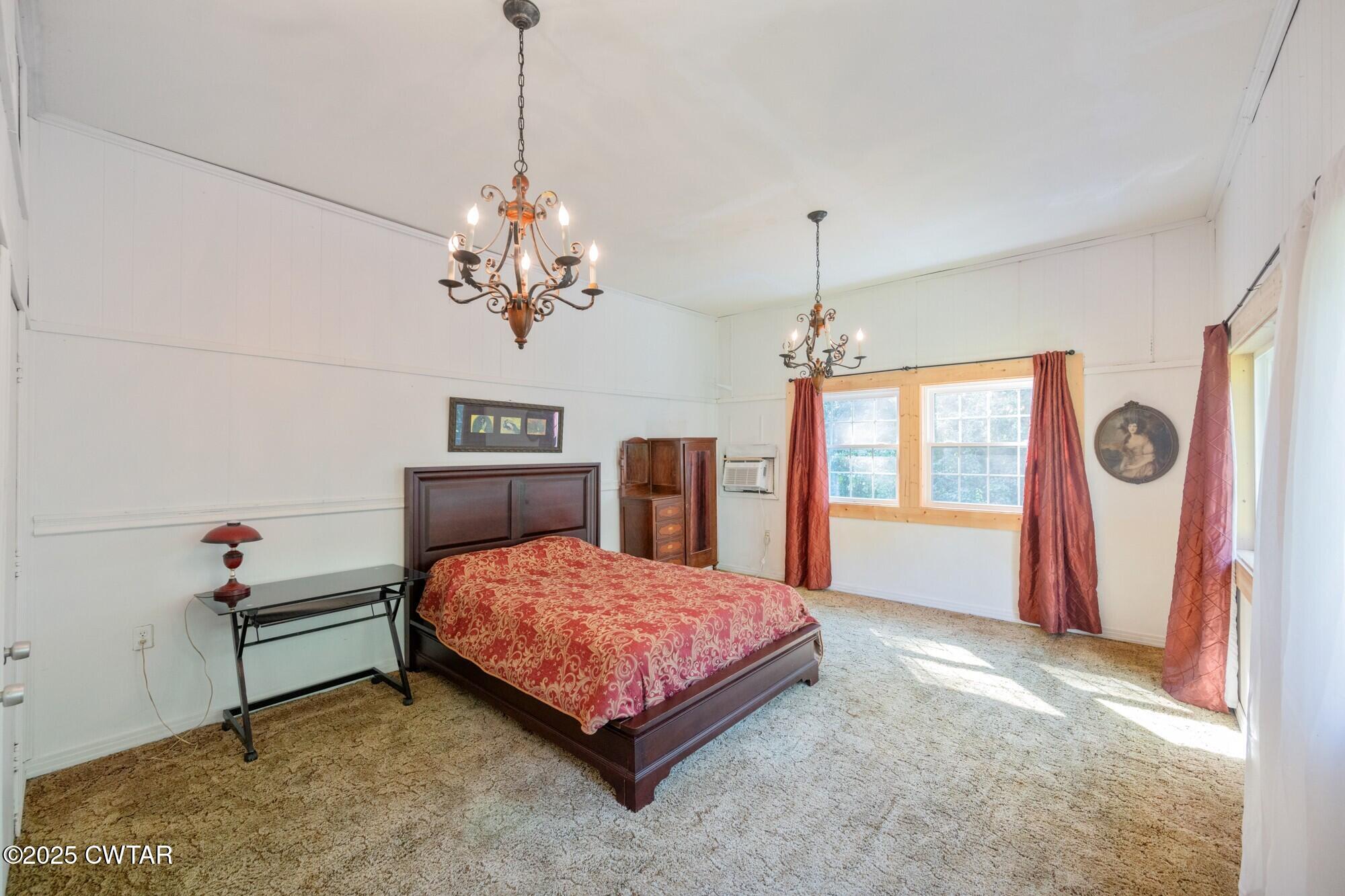 1035 Beacon Road Parsons, TN 38363 - Photo 40 of 70 a bedroom with a bed chandelier and a window